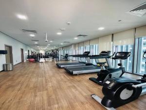 a gym with treadmills and elliptical machines at MontRose residence Tower A 1BR Apartment in Dubai