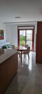a kitchen with a table and chairs in a room at Apartamentos Corea in Portonovo