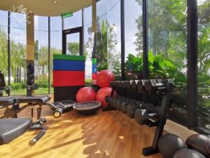 a gym with some exercise equipment in a room with windows at Trion Kuala Lumpur For KLCC view BLOCK C in Kuala Lumpur