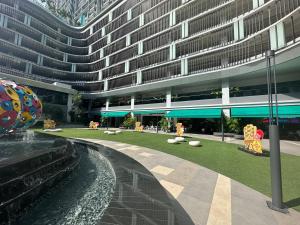 a large building with a fountain in front of a building at Trion Kuala Lumpur For KLCC view BLOCK C in Kuala Lumpur