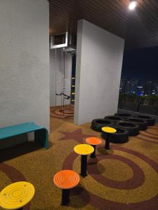 a room with stools with frisbees on the floor at Trion Kuala Lumpur For KLCC view BLOCK C in Kuala Lumpur