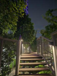a wooden walkway with a gate at night at Trion Kuala Lumpur For KLCC view BLOCK C in Kuala Lumpur