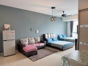 a living room with a couch and a refrigerator at Rainforest City House Paradigm Skudai UTM TVBox in Johor Bahru +11 photos