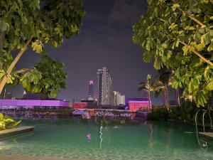 a swimming pool with a city skyline in the background at Trion Kuala Lumpur For KLCC view BLOCK C in Kuala Lumpur