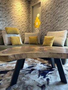 a wooden bench in a room with a brick wall at Trion Kuala Lumpur For KLCC view BLOCK C in Kuala Lumpur