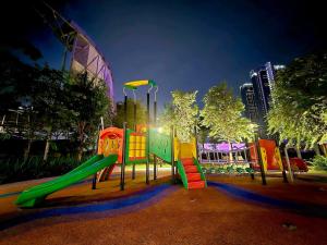 a playground with a slide in a park at night at Trion Kuala Lumpur For KLCC view BLOCK C in Kuala Lumpur