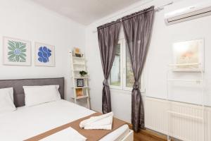 Ένα ή περισσότερα κρεβάτια σε δωμάτιο στο Adamou Family House