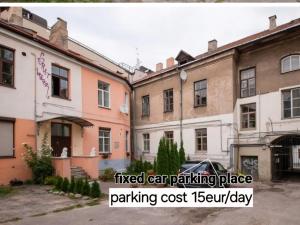 a group of buildings with the text fixed car parking place parking cost jealousy at HaPPy iNN ToTo Old Town, Self check, Parking in the yard, in Vilnius +15 photos