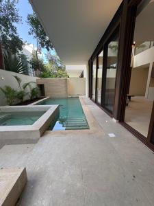 a swimming pool in the middle of a house at Luxury Exclusive Villa in Playa del Carmen