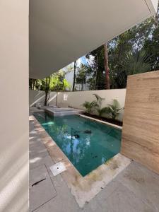a swimming pool in the middle of a house at Luxury Exclusive Villa in Playa del Carmen +7 photos