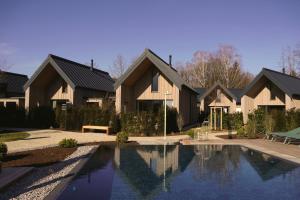 a house with a swimming pool in front of it at Agrad Chalets in Aschau im Chiemgau