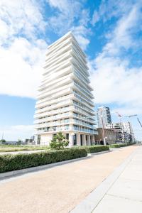 a tall white building in a city at Luxurious new apartment with stunning views in Ostend