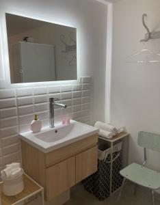 a bathroom with a sink and a mirror at Cottage normand de 1930 in Manneville-sur-Risle +29 photos