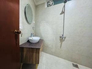 a bathroom with a sink and a mirror at The Hermitage Cottage-Exclusive Mountain Escape in Murree