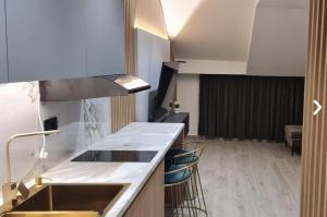 a kitchen with a sink and a counter top at Apartman La Casa and Spa in Vranje