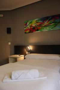 a bedroom with a bed with two towels on it at Hotel Tierra de Garnacha in Borja +17 photos