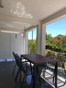 a table and chairs in a room with a balcony at Apartments Bucića Dvori in Starigrad-Paklenica