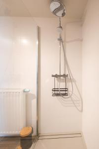 a light hanging from a wall in a room at Wonderful new apartment close to the beach in Ostend +24 photos