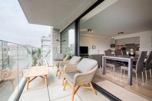 an open living room and dining room with a table and chairs at Wonderful new apartment close to the beach in Ostend