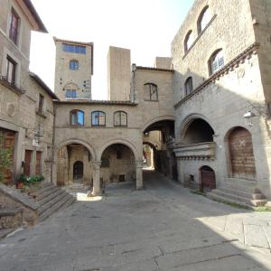 an empty alley in an old building with stone buildings at Boccaletto Incantato in Viterbo