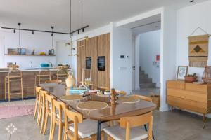 a dining room and kitchen with a table and chairs at Villa Avalon by Abahana Luxe in Benitachell +26 photos