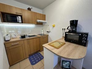 a small kitchen with a counter with a microwave at Adour e vita in Pontonx-sur-lʼAdour +14 photos