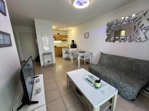 a living room with a couch and a table at Adour e vita in Pontonx-sur-lʼAdour