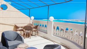 a rendering of a balcony with tables and chairs at Halla Matrouh Sea View in Marsa Matruh