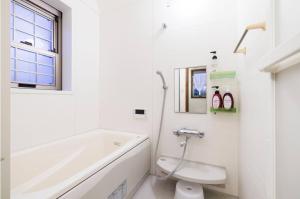 a bathroom with a tub and a toilet and a sink at アンティークス岐阜関 Antiques Gifu Seki in Sekimachi +43 photos