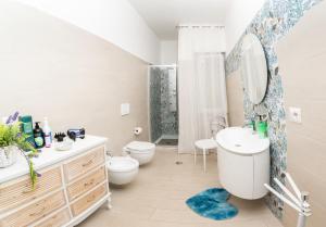 a bathroom with a sink toilet and a shower at DanysHome Circe davanti al mare in Terracina