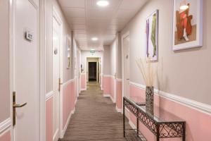 a corridor in a hospital with pink walls at Best Western Hotel Lakmi Nice in Nice