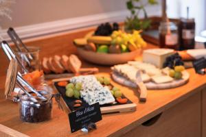 a table with cheese and other foods on a counter at Best Western Hotel Lakmi Nice in Nice