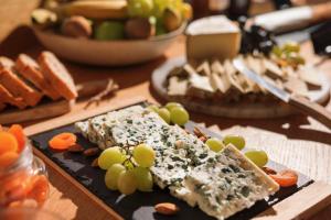 a plate of food with grapes and cheese on a table at Best Western Hotel Lakmi Nice in Nice