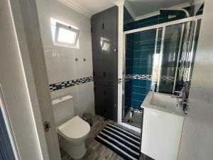 a bathroom with a toilet and a sink at Casa rooftop jacuzzi and magnificent sea view in Albufeira +32 photos