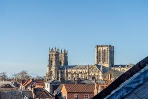 a view of a cathedral from the roofs of buildings at The Shambles - Attic in York +5 photos