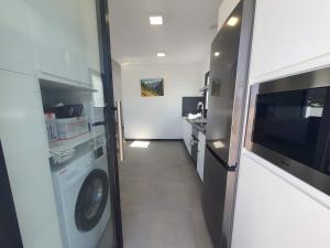 a laundry room with a washer and dryer at Casa Camino Real in Los Barros
