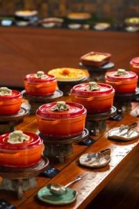 a table topped with pies and other food items at Hotel Fazenda Morros Verdes Ecolodge in Ibiúna