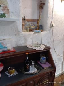 a glass jar sitting on top of a wooden table at Casa de Aldeia Vale do Mondego in Guarda