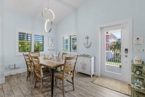 a dining room with a wooden table and chairs at Welcome to Mermaid Bay Vacation Rental - 261 Delmar home in Fort Myers Beach