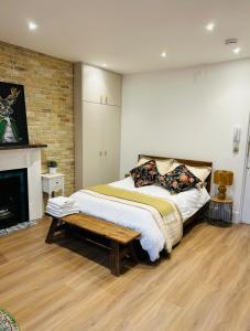 a bedroom with a bed and a fireplace at Studio flat in Fitzrovia in London