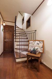 a room with a staircase with a table and a door at アンティークス岐阜関 Antiques Gifu Seki in Sekimachi