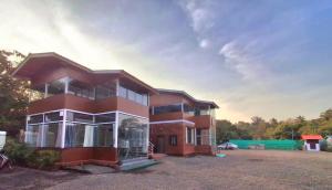 a large brick building with a lot of windows at Mai's Beach Resort in Malvan