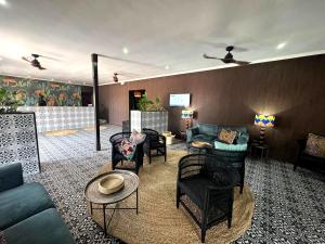 a living room with couches and chairs at Elephant Springs in Bela-Bela