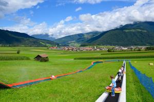 a group of children playing on a toy track at Boutique Hotel Am Park in Valdaora +107 photos