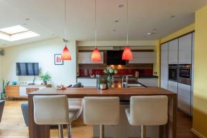 a kitchen with a large wooden table and chairs at Bath City Haven with Free Parking in Bath