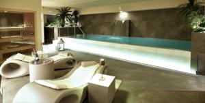 a bathroom with two toilets and a swimming pool at SANTA CHIARA SUITE HOTEL & SPA - Lecce in Lecce