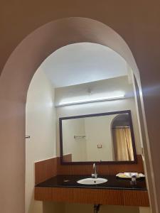 a bathroom with a sink and a large mirror at Kappad Beach Resort in Kappad +42 photos