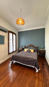 a bedroom with a large bed with a wooden floor at Meridiano Hostel Boutique in Buenos Aires +72 photos
