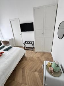 a bedroom with a bed and a table and a mirror at Palazzo Pietrarsa in Naples
