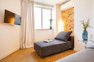 a living room with a couch and a tv at Apartment Musala N 01 in Varna City